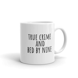 May include: White ceramic mug with black text that reads "True Crime and Bed by Nine".
