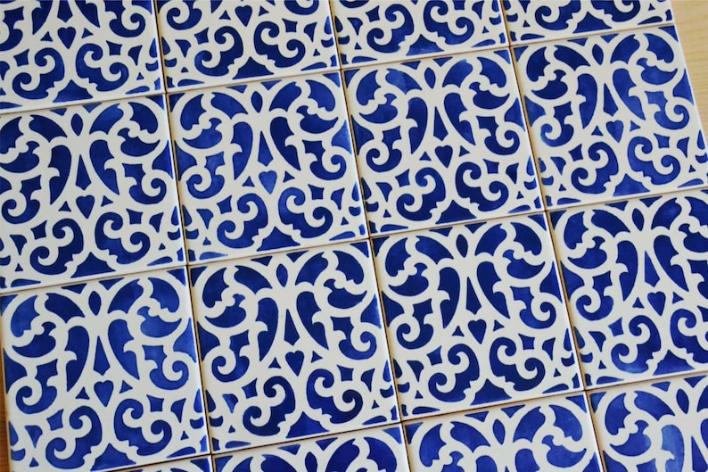 May include: A pattern of blue and white ceramic tiles with a decorative, intricate design. The tiles are arranged in a grid pattern.