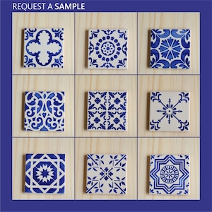 Op de afbeelding: Negen blauwe en witte keramische tegels met verschillende geometrische patronen. De tegels zijn gerangschikt in een 3x3 raster op een houten oppervlak.  "REQUEST A SAMPLE" staat in witte tekst op een blauwe achtergrond bovenaan de afbeelding.