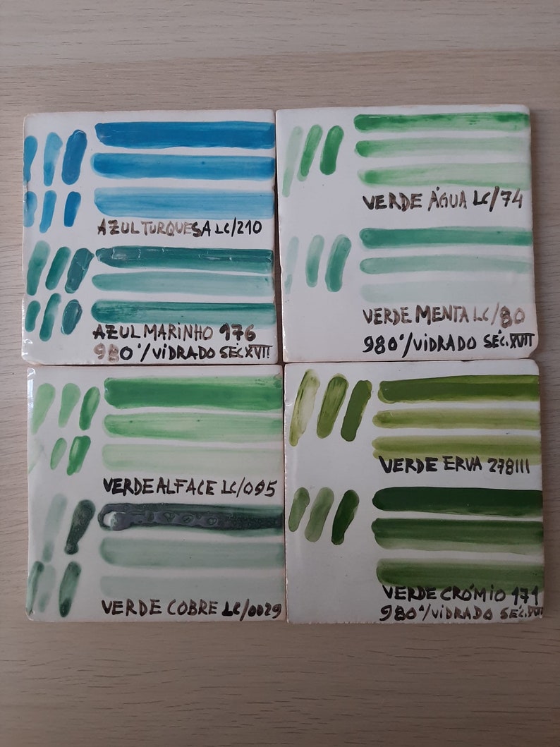 May include: Four ceramic tiles with painted stripes in shades of blue and green. Each tile has a label with the color name and a code, such as "AZUL TURQUESA LC/210" and "VERDE &Aacute;GUA LC/74".