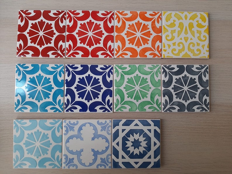 May include: Ten ceramic tiles with various geometric patterns in blue, green, red, yellow, and white. The tiles are arranged in two rows of five.