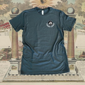 May include: A dark blue t-shirt with a white circle logo on the left chest. The logo features a stylized "M" with a small circle inside. The text "YOUR LOGO" is below the logo.