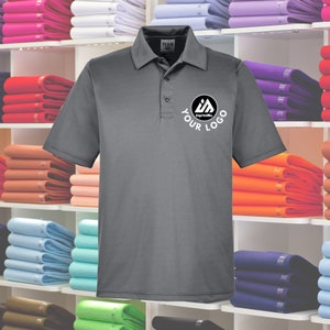 May include: A charcoal gray polo shirt with a white logo that says "Your Logo" and "ImprintMe" in a circle. The shirt has a button-down collar and short sleeves.