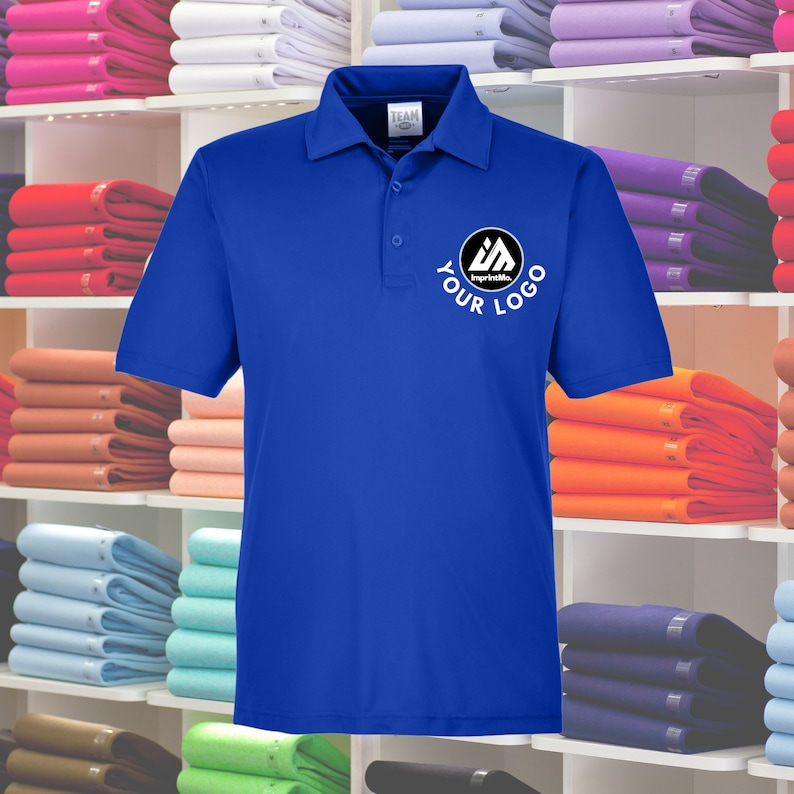 May include: A royal blue polo shirt with a white collar and short sleeves. The shirt has a black circle with a white logo and the text "YOUR LOGO" in white.