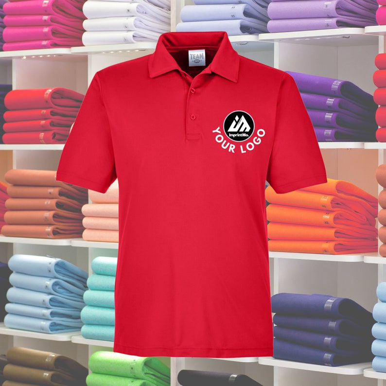 May include: Red polo shirt with a white logo that says "Your Logo" and "ImprintMe" in a circle on the left chest.