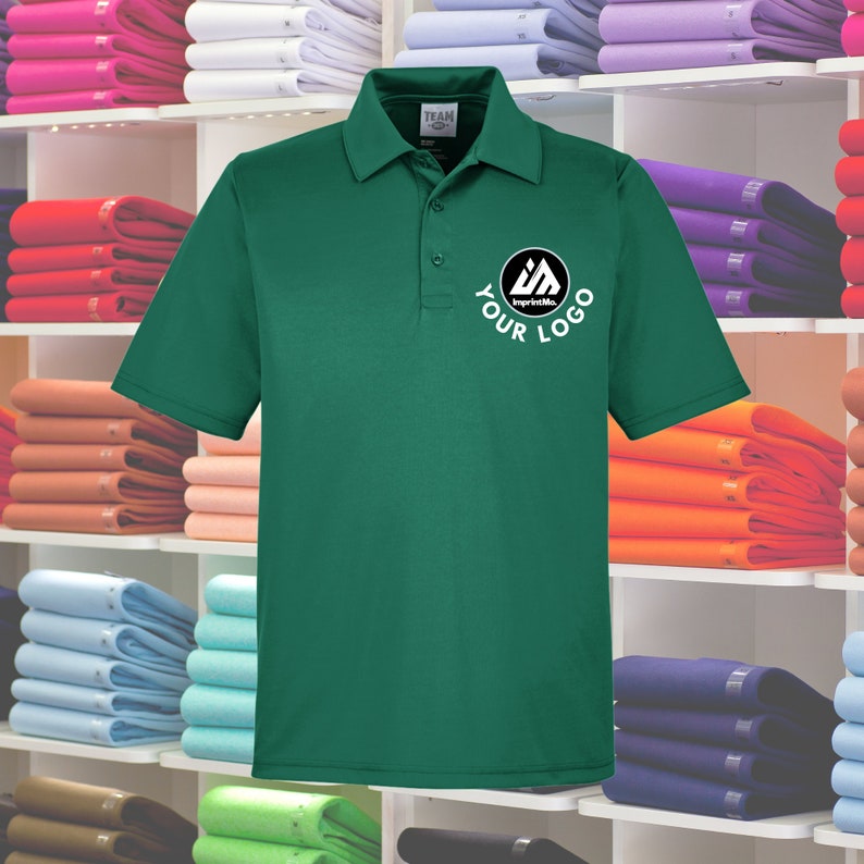 May include: A green polo shirt with a white logo that says "ImprintMe" and "YOUR LOGO".