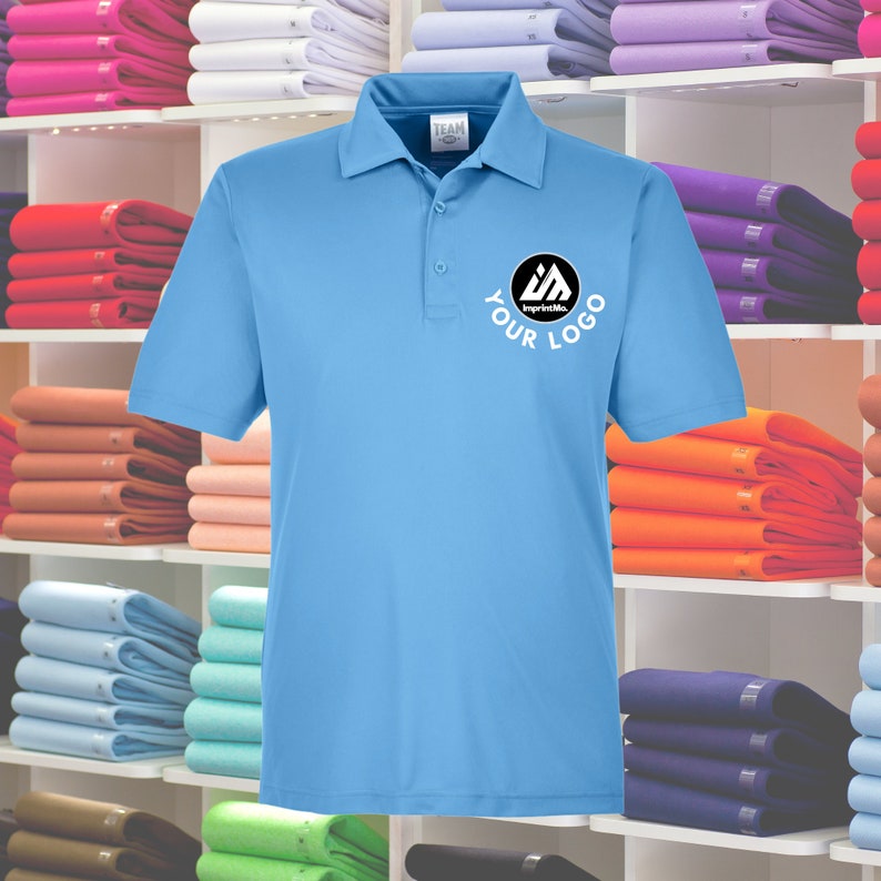 May include: A light blue polo shirt with a black circle logo that says "YOUR LOGO" and "ImprintMe." in white text.