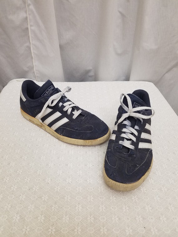 white adidas with navy blue stripes