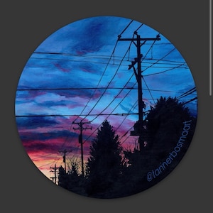 May include: A watercolor painting of a sunset sky with power lines and silhouetted trees. The sky is a vibrant mix of pink, purple, and blue, with wispy clouds. The power lines are a dark blue, and the trees are a dark green. The painting is signed "@tannerbosmaart" in the lower right corner.