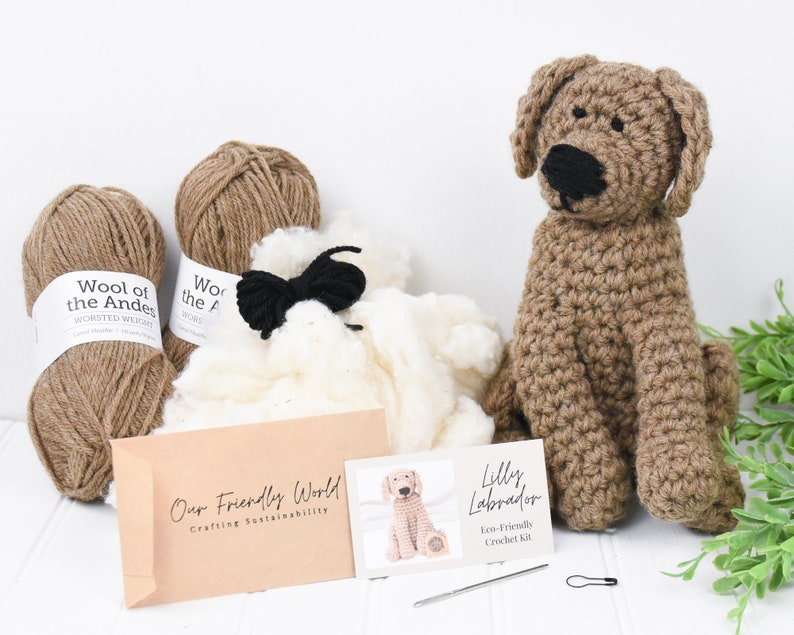 May include: A brown crochet kit for making a Labrador puppy. The kit includes brown yarn, white stuffing, black yarn for the nose and eyes, and a crochet hook. The kit also includes a brown crocheted Labrador puppy.