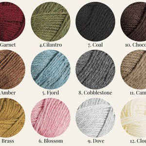 May include: Twelve yarn skeins in various colors, including garnet, cilantro, coal, chocolate, amber, fjord, cobblestone, camel, brass, blossom, dove, and cloud.