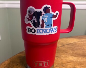 May include: Red Yeti tumbler with a sticker of two football players and the text "BO KNOWS".