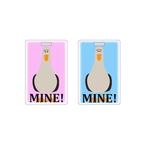 May include: Two pink and blue rectangular tags with a cartoon seagull and the text "MINE!" in black.