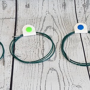 Sujetacables para agujas de tejer