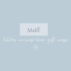 May include: Pale blue background with the text "Mahi" in grey, and the words "holiday eco-swap! linen gift wraps" in a cursive font. A snowflake graphic is at the bottom. The Mahi logo has a floral design.