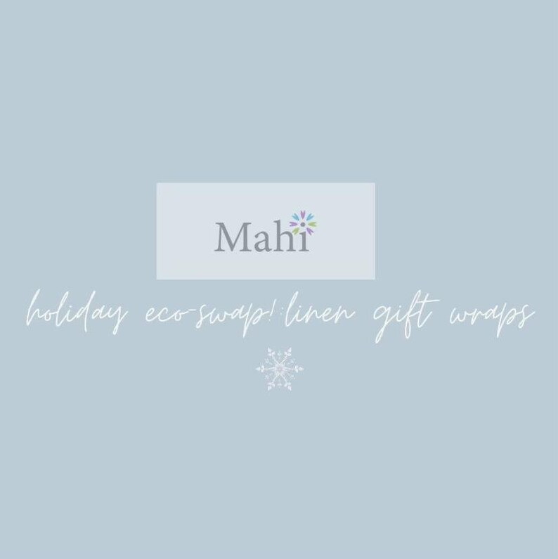 May include: Pale blue background with the text "Mahi" in grey, and the words "holiday eco-swap! linen gift wraps" in a cursive font. A snowflake graphic is at the bottom. The Mahi logo has a floral design.