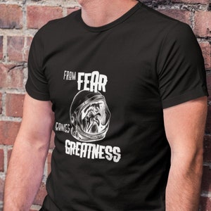 From Fear Comes Greatness T-Shirt, Inspirational Graphic Short-Sleeve Unisex T-Shirt. And it's got a chicken in a space helmet.