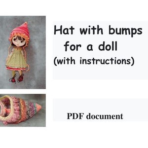 Könnte beinhalten: Eine gestrickte Mütze mit Noppen für eine Puppe in den Farben Rosa, Orange und Braun. Die Mütze hat eine spitze Spitze und einen Rand. Das Bild zeigt auch ein PDF-Dokument mit Anleitungen zum Herstellen der Mütze.