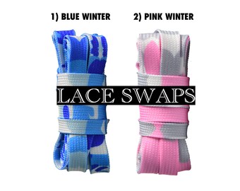May include: Flat camouflage print shoelaces labeled LACE SWAPS. Two sets are shown: 1) Blue Winter, featuring shades of blue and light blue, and 2) Pink Winter, featuring pink and grey tones. The text states color may vary due to monitors.