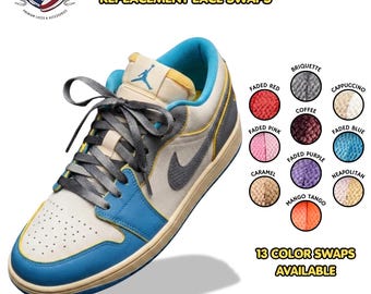 May include: A low-top sneaker with a cream, blue, and grey color scheme, featuring a Jumpman logo on the tongue and grey laces. The image includes text reading SB DUNK COMPATIBLE REPLACEMENT LACE SWAPS and displays 13 color swatches for laces.