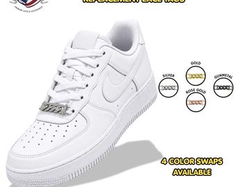 May include: A white sneaker featuring a silver-toned diamond chain link dubrae lace tag. The image displays the text Diamond Chain Link Dubrae Replacement Lace Tags and 4 Color Swaps Available, with circular icons showing silver, gold, rose gold, and gunmetal.