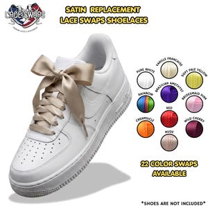 May include: A white sneaker featuring wide, champagne-colored satin shoelaces tied in a large bow. The image includes the text "SATIN REPLACEMENT LACE SWAPS SHOELACES" and "22 COLOR SWAPS AVAILABLE" alongside a circular color chart of various laces.