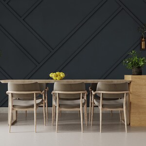 May include: A dining room set with a wooden table and four chairs. The table has a bowl of lemons on it. The wall behind the table is dark gray with a geometric pattern.
