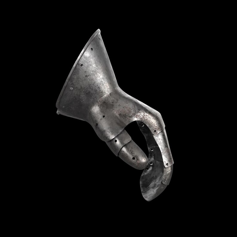 May include: A metallic gauntlet piece featuring a flared cuff and articulated finger segments. The surface displays a weathered, dark grey finish with visible rivets along the joints and edges, showing a segmented construction for hand protection.