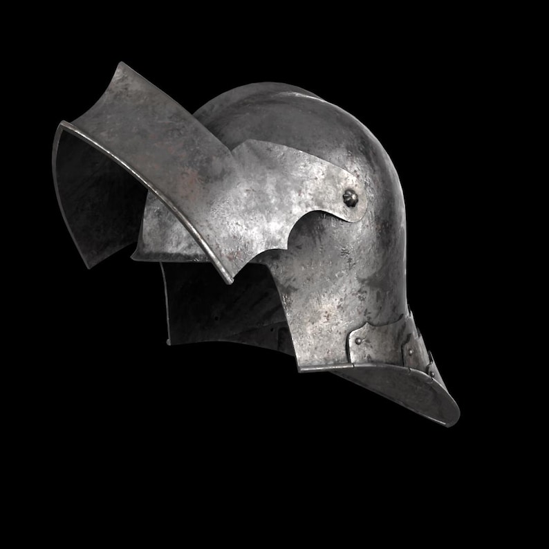 May include: A weathered, metallic helmet with a curved visor and neck guard. The helmet has a riveted construction and a slightly tarnished finish, suggesting age and use. The design is reminiscent of medieval armor.