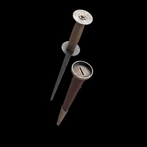 May include: A dagger with a wooden handle and a metal blade, accompanied by a brown sheath with metal accents. The dagger's handle has a circular guard and a decorative top.