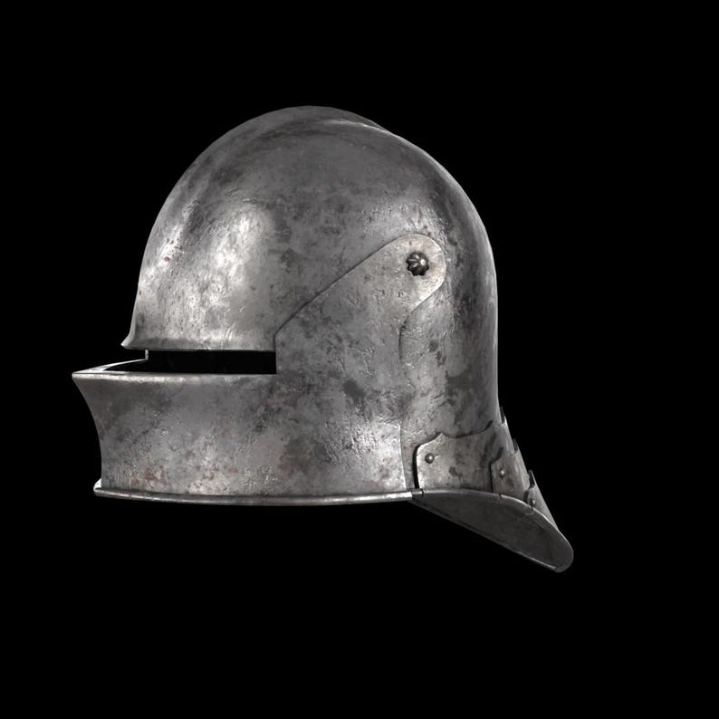 May include: A weathered, steel helmet with a rounded top and a visor. The helmet has a riveted construction and a dark, aged appearance. The visor is slightly angled, and the helmet appears to be of medieval design.