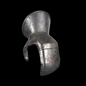 May include: A metallic gauntlet piece featuring a flared cuff with a series of small circular holes along the edge. The armour component is constructed from articulated steel plates with a weathered, textured surface and visible signs of oxidation.