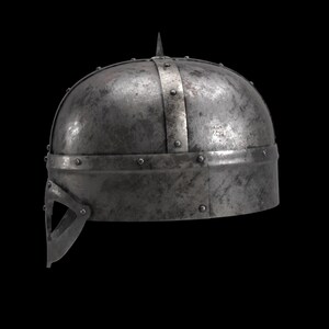 May include: A weathered, metallic helmet with a pointed top and riveted construction. The helmet features a visor and a band around the base. The overall design suggests a historical or medieval theme.
