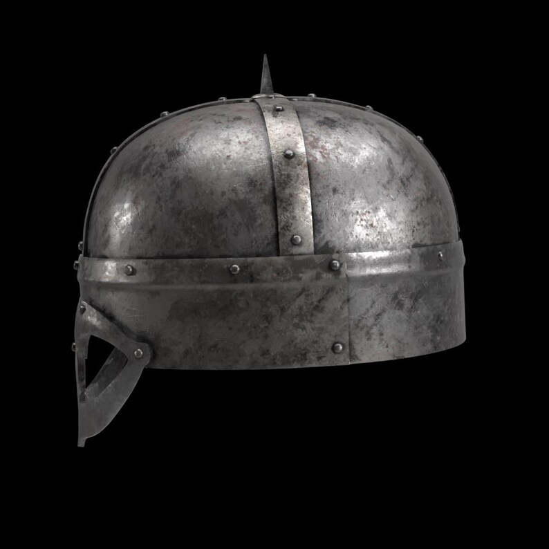 May include: A weathered, metallic helmet with a pointed top and riveted construction. The helmet features a visor and a band around the base. The overall design suggests a historical or medieval theme.