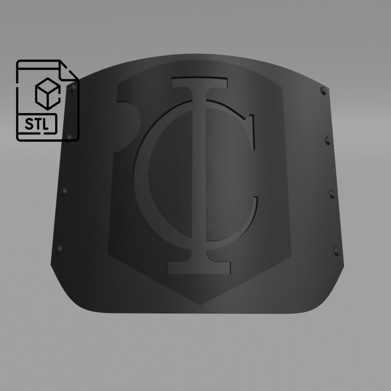May include: A black metal shield with a stylized letter "I" and a circle around it. The shield has a rounded top and a flat bottom. There are small rivets around the edges of the shield.