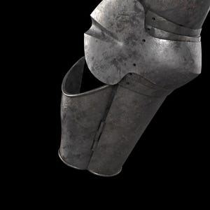 May include: A metallic arm armor piece featuring a dark, weathered steel finish. The component includes a hinged lower section and a rounded elbow guard with visible rivets, showcasing a segmented construction designed for joint articulation.