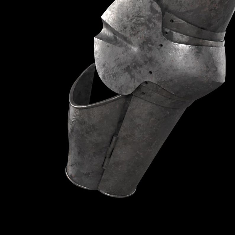May include: A metallic arm armor piece featuring a dark, weathered steel finish. The component includes a hinged lower section and a rounded elbow guard with visible rivets, showcasing a segmented construction designed for joint articulation.