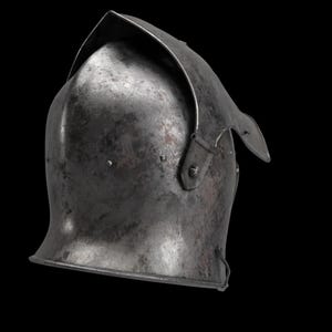 May include: A weathered, steel helmet with a curved visor and a pointed top. The helmet has a riveted construction and a dark, metallic finish, suggesting historical use. The background is black.