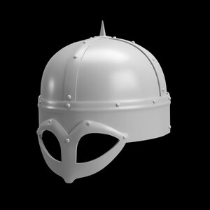 May include: A light gray Viking helmet with a pointed top and a face guard. The helmet has a rounded crown and is adorned with rivets and a decorative band around the base. The face guard features eye openings.