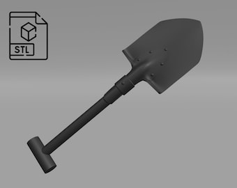 May include: A black folding shovel with a T-shaped handle. The shovel is made of metal and has a matte finish.