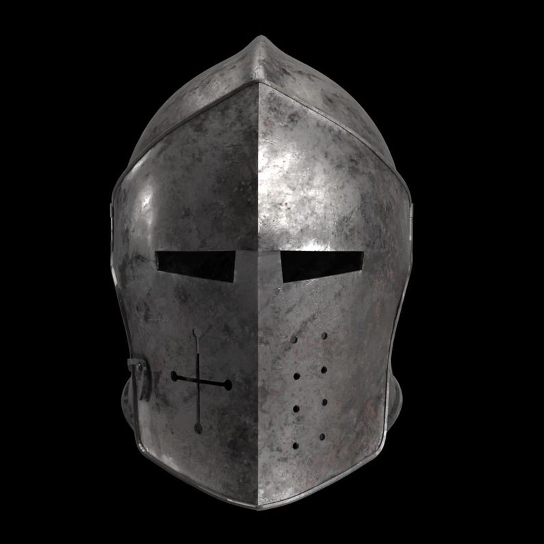 May include: A weathered, metallic knight's helmet with a cross emblem on the front. The helmet features eye slits and ventilation holes, showcasing a medieval design. The helmet's surface has a worn, textured appearance, suggesting age and use.