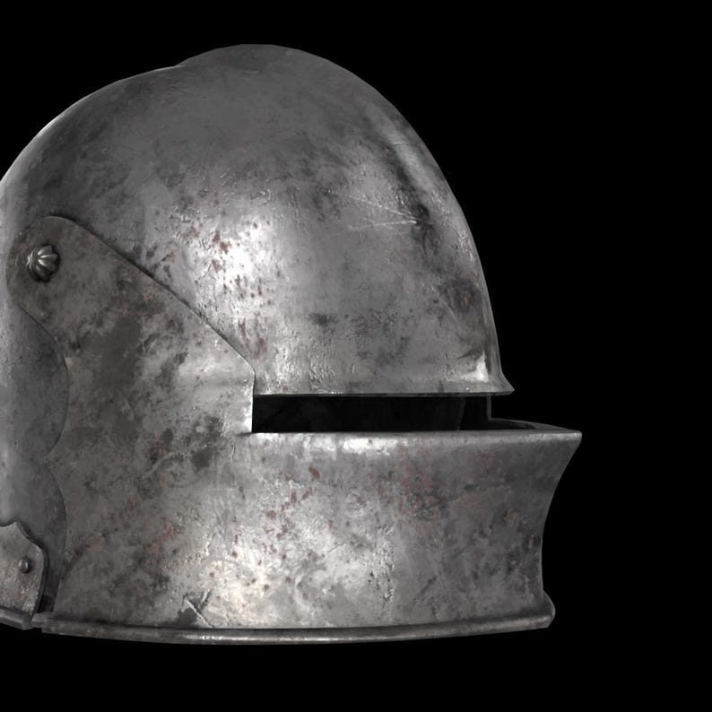 May include: A weathered, steel-colored medieval helmet with a rounded top and a visor. The helmet shows signs of age with visible scratches and discoloration, suggesting historical use. The visor has a horizontal opening for the eyes.