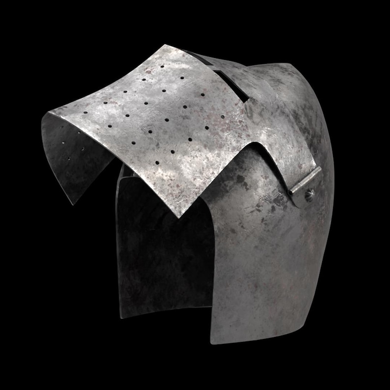 May include: A weathered, steel helmet with a distinctive visor featuring small ventilation holes. The helmet's design includes a curved top and a riveted side piece, suggesting historical or medieval origins. The metal has a worn, aged appearance.