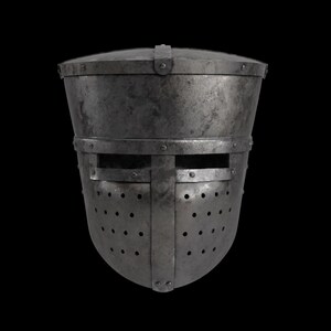 May include: A medieval steel helmet with a rounded top and a faceplate featuring horizontal eye slits and numerous small ventilation holes. The helmet is riveted together and has a dark, aged appearance.