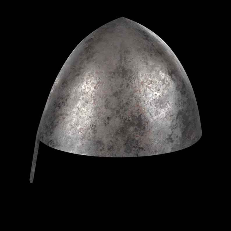 May include: A weathered, metallic helmet with a rounded top and a pointed apex. The helmet has a slightly curved brim and a distressed, textured surface, suggesting age and use. The color is a muted gray with darker patches.