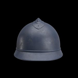 May include: A blue-gray helmet with a rounded top and a flared brim. The helmet has a small, pointed detail at the top and a decorative element at the front. The background is black.