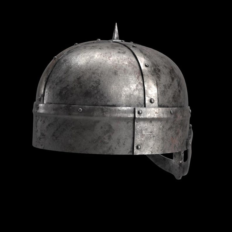 May include: A weathered, metallic helmet with a pointed top and riveted construction. The helmet has a rounded crown and a horizontal band around the base, suggesting a medieval or historical theme.