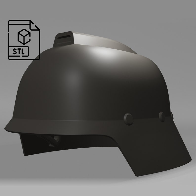 May include: A black plastic helmet with a visor and a small ridge on the top. The helmet has two small black dots on the side.
