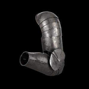 May include: A metallic arm armor piece featuring a series of overlapping steel plates for the upper arm, a cylindrical forearm section, and a circular elbow guard. The surface has a weathered, dark grey finish with visible rivets and seams.