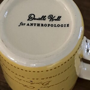 May include: A set of three ceramic mugs with a speckled, matte finish. The mugs are in shades of cream, light gray, and dark gray. Each mug has a simple, minimalist design, perfect for coffee or tea.